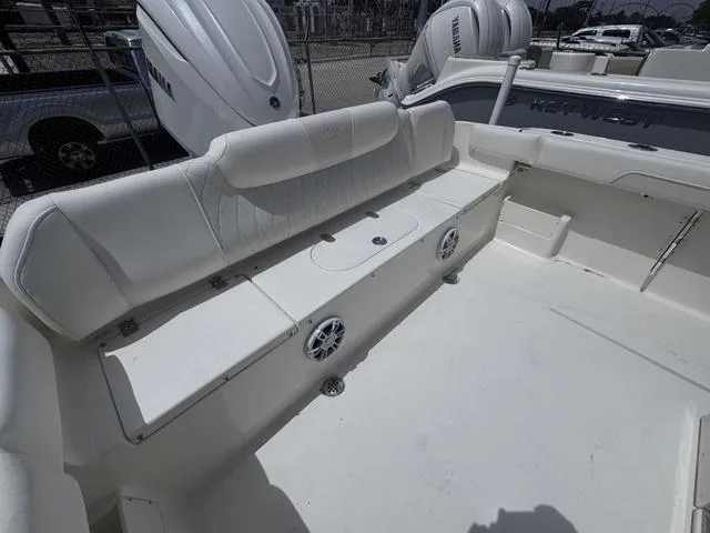 Slide: The Image of 2025 Key West 239 FSR boat interior with white seating and speakers. - 11