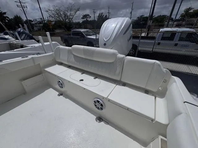 Slide: The Image of 2025 Key West 239 FSR boat interior with white seating and speakers. - 12