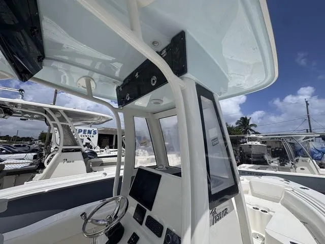 Slide: The Image of 2025 Key West 239 FSR boat interior with steering wheel and control panel. - 5
