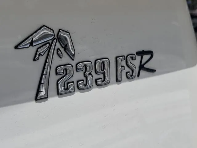 Slide: The Image of Key West 239 FSR 2025 model emblem with palm tree design on white surface. - 8