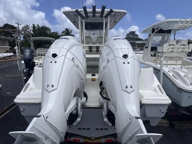 Slide: The Image of 2025 Key West 260 CC boat with dual outboard engines, docked under a clear sky. - 3