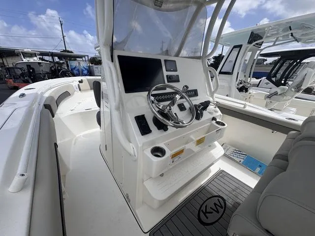 Slide: The Image of 2025 Key West 260 CC boat interior with modern helm and steering wheel. - 6