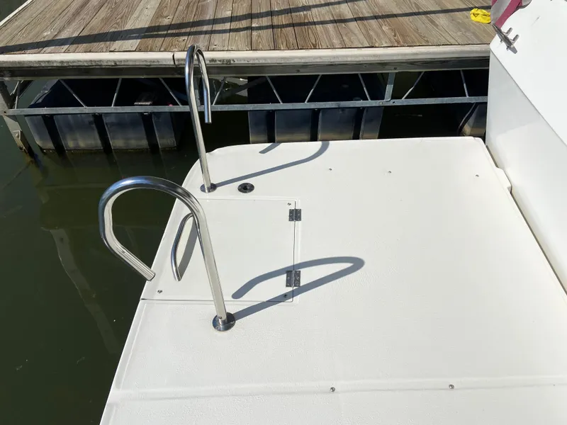 Slide: The Image of 2008 Meridian 490 Pilothouse swim platform with stainless steel handrails. - 10