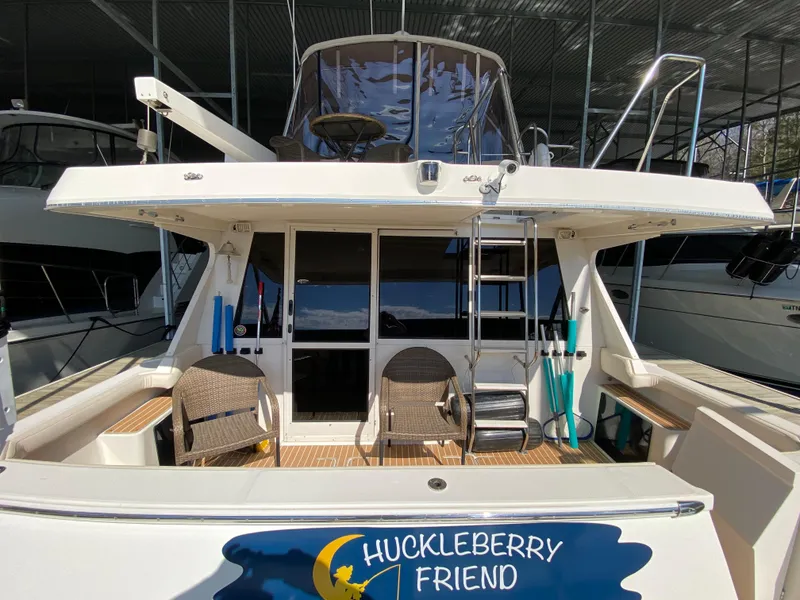 Slide: The Image of 2008 Meridian 490 Pilothouse yacht, rear view, docked with seating and ladder. - 12