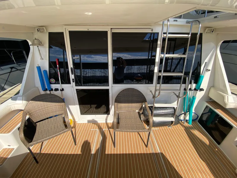 Slide: The Image of 2008 Meridian 490 Pilothouse deck with chairs and ladder, featuring a sleek design. - 13