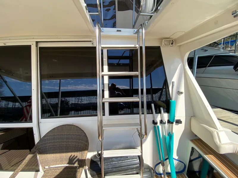 Slide: The Image of Stainless steel ladder on 2008 Meridian 490 Pilothouse yacht deck, with seating and dock view. - 17