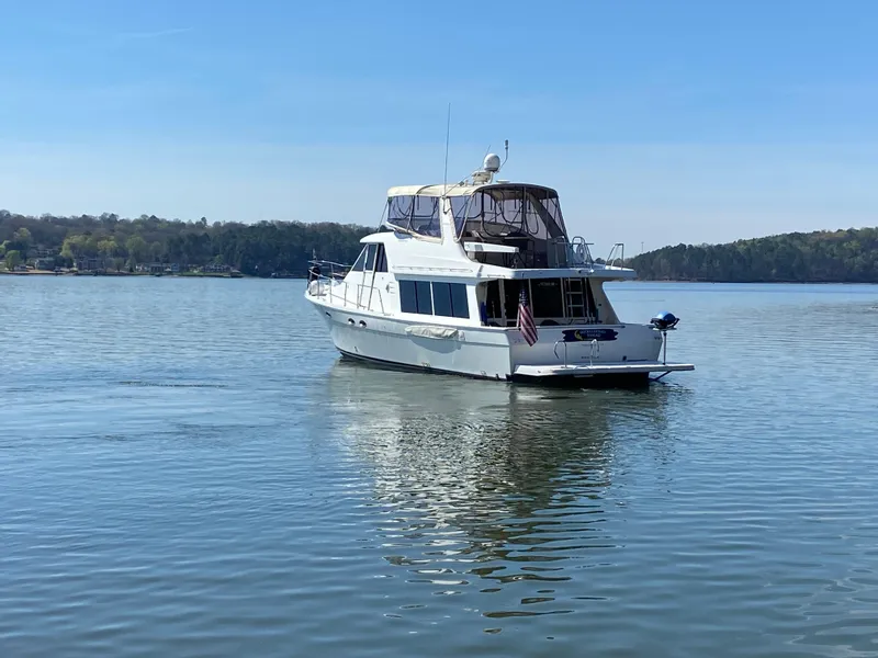 Slide: The Image of 2008 Meridian 490 Pilothouse yacht on a serene lake. - 2