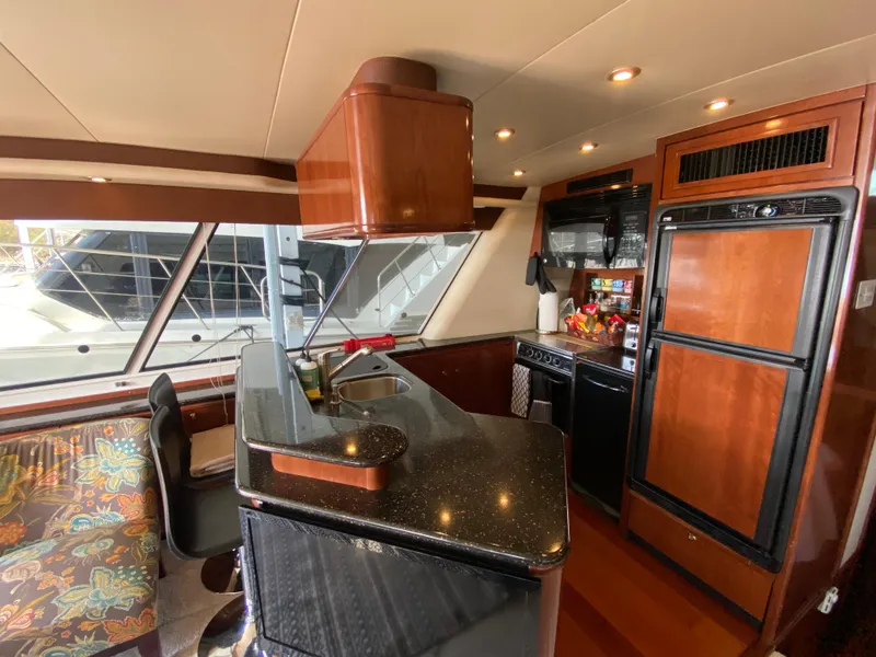 Slide: The Image of Luxurious 2008 Meridian 490 Pilothouse yacht interior with modern kitchen and elegant wood finishes. - 20