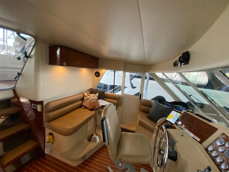 Slide: The Image of Interior of 2008 Meridian 490 Pilothouse with seating, helm, and wooden flooring. - 25