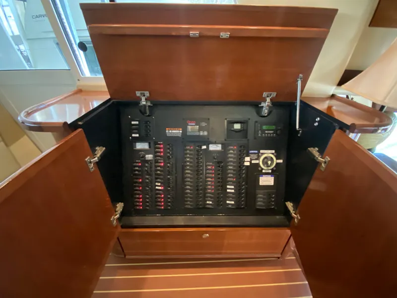 Slide: The Image of Electrical panel inside a 2008 Meridian 490 Pilothouse yacht, showcasing circuit breakers and controls. - 27