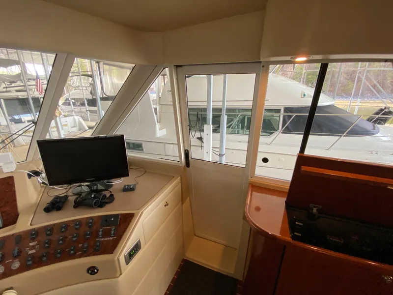 Slide: The Image of Interior view of a 2008 Meridian 490 Pilothouse yacht cockpit with control panel and monitor. - 28