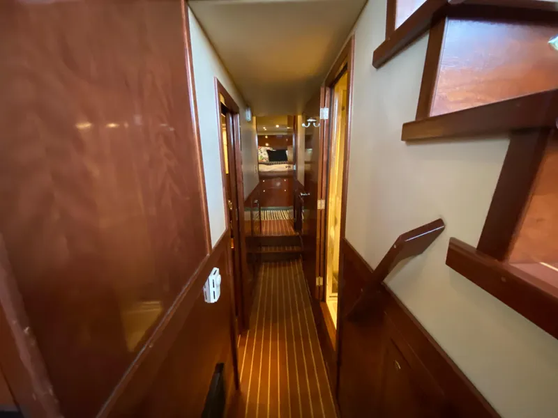 Slide: The Image of 2008 Meridian 490 Pilothouse interior hallway with wooden finishes and staircase. - 31