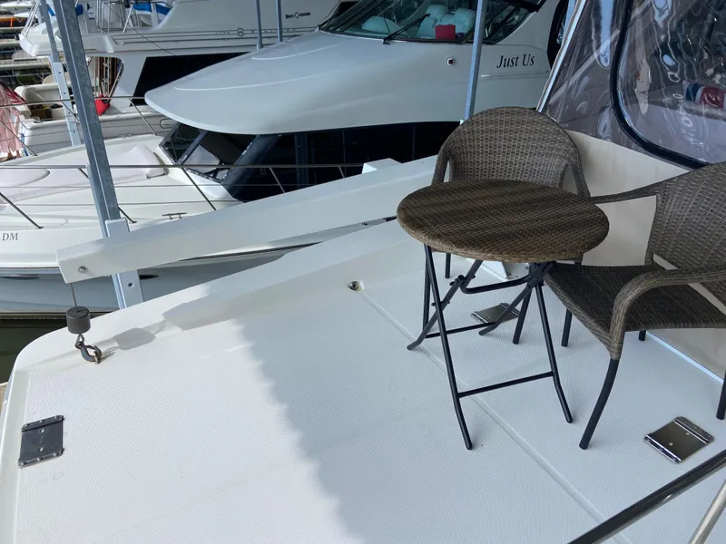 Slide: The Image of 2008 Meridian 490 Pilothouse yacht deck with chairs and table, docked at marina. - 42