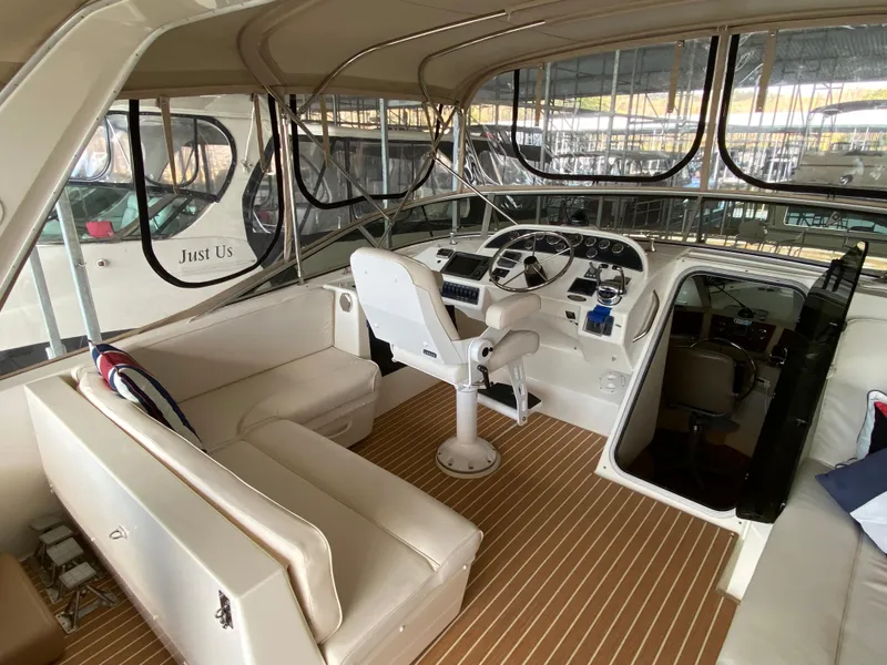 Slide: The Image of 2008 Meridian 490 Pilothouse interior with helm, seating, and wood flooring. - 44