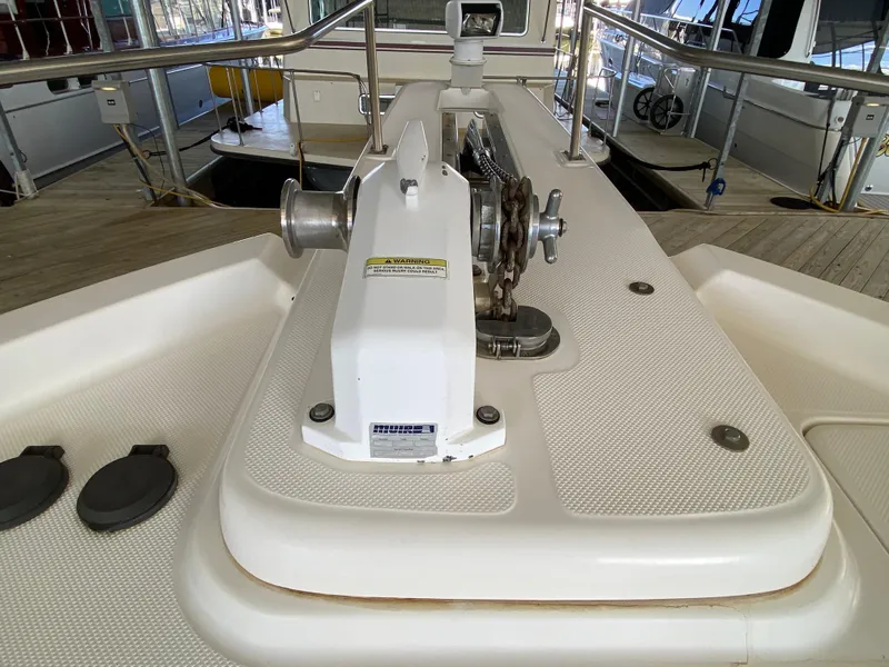 Slide: The Image of 2008 Meridian 490 Pilothouse yacht deck with anchor winch and railing. - 49