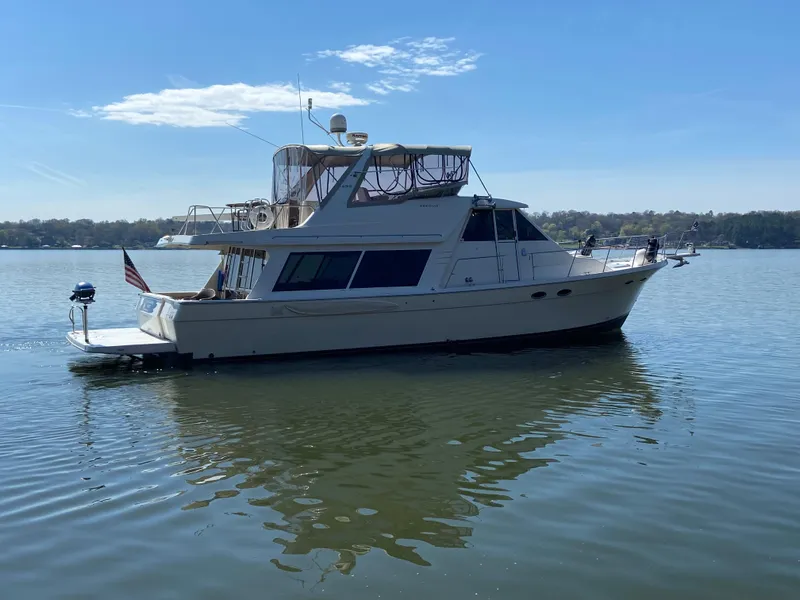 Slide: The Image of 2008 Meridian 490 Pilothouse yacht on calm water, side view. - 6