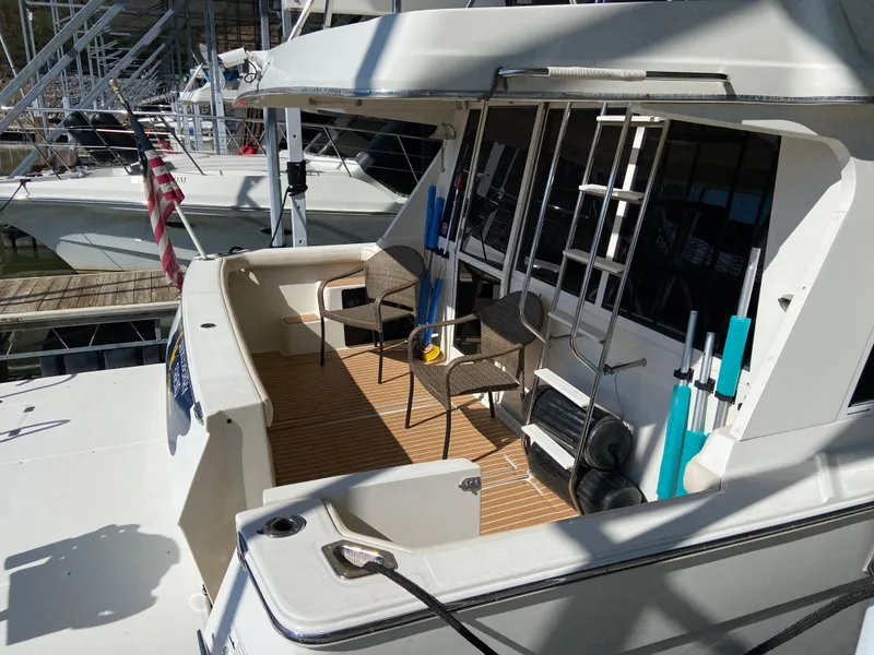 Slide: The Image of 2008 Meridian 490 Pilothouse yacht with spacious deck and seating area. - 8