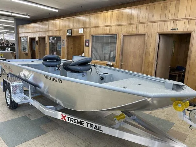 Slide: The Image of 2025 XTREME BOATS Brute 1648 SS on trailer in showroom. - 1