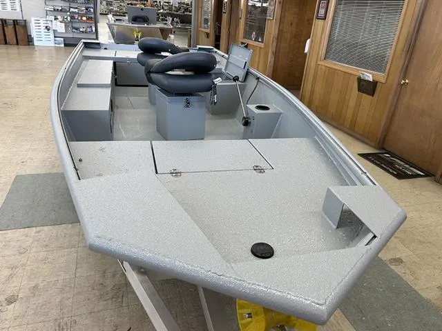 Slide: The Image of 2025 XTREME BOATS Brute 1648 SS in showroom, featuring spacious deck and seating. - 2