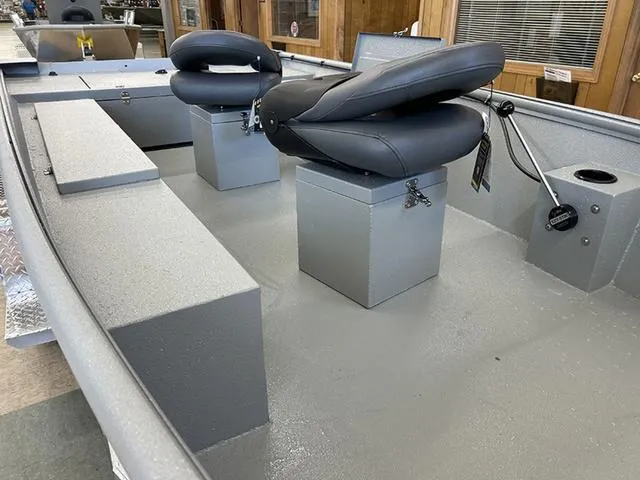 Slide: The Image of 2025 XTREME BOATS Brute 1648 SS interior with dual seats and storage compartments. - 3