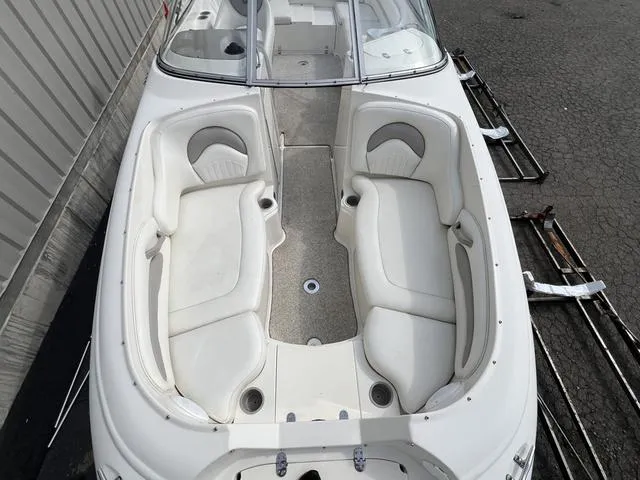 Slide: The Image of 2005 Stingray 220 DR boat with white seating and open deck layout. - 10