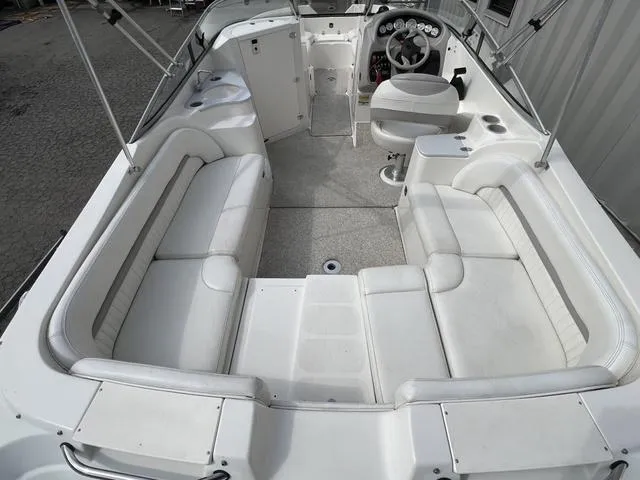 Slide: The Image of 2005 Stingray 220 DR boat interior with white seating and steering console. - 4