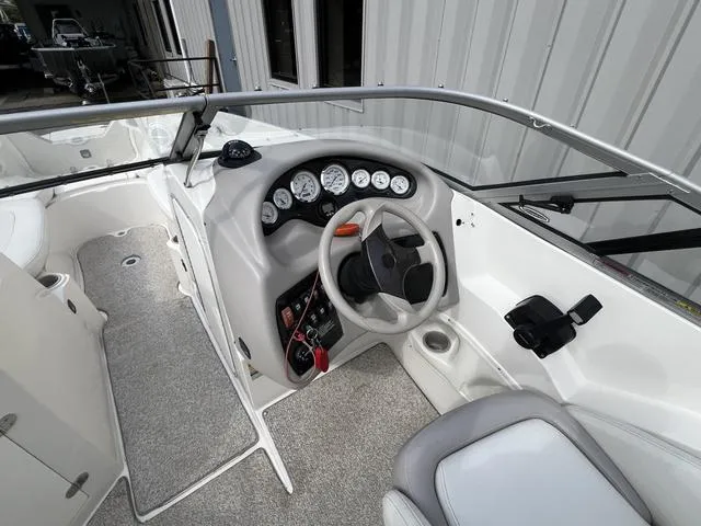 Slide: The Image of 2005 Stingray 220 DR boat cockpit with steering wheel and instrument panel. - 6