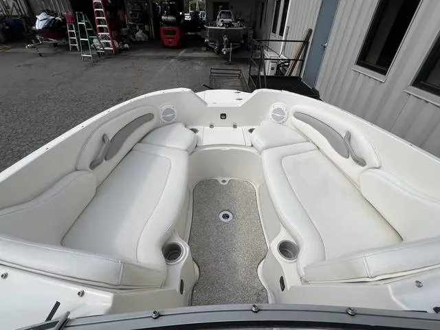 Slide: The Image of 2005 Stingray 220 DR boat interior with white seating and cup holders. - 9