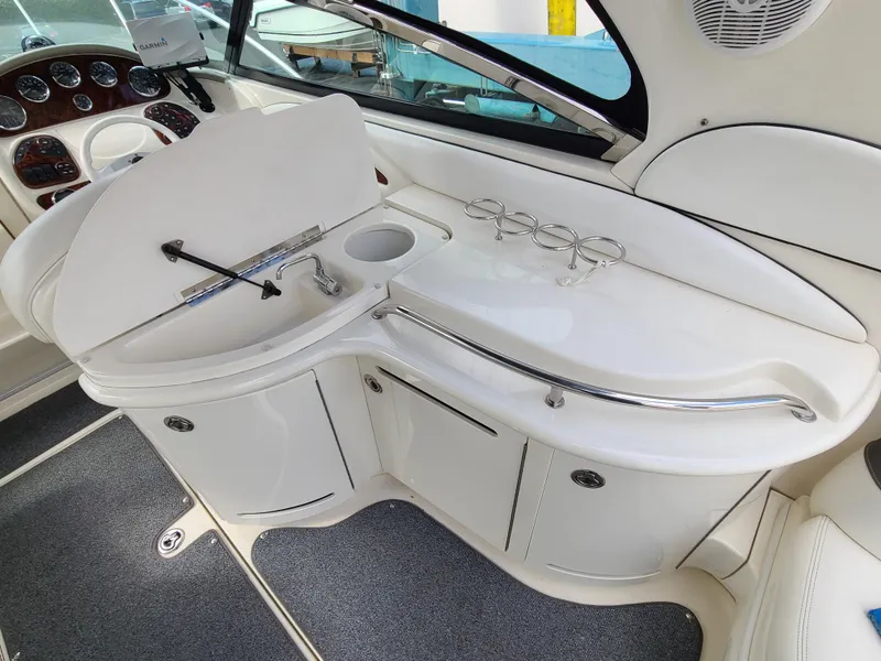 Slide: The Image of 2006 Sea Ray 290 Sun Sport interior with sink and cup holders. - 11