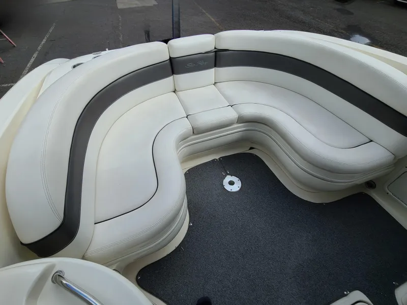 Slide: The Image of 2006 Sea Ray 290 Sun Sport boat interior with curved white seating. - 12