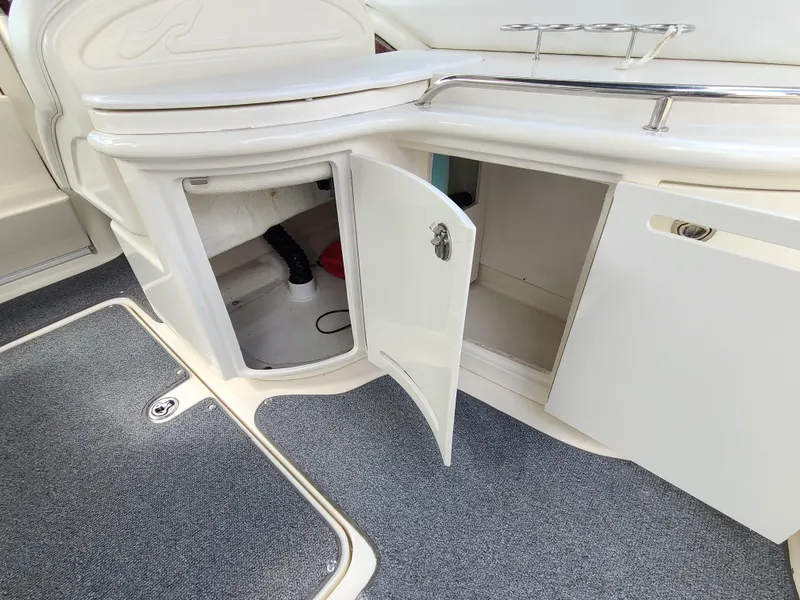Slide: The Image of 2006 Sea Ray 290 Sun Sport interior storage compartments with open doors. - 14