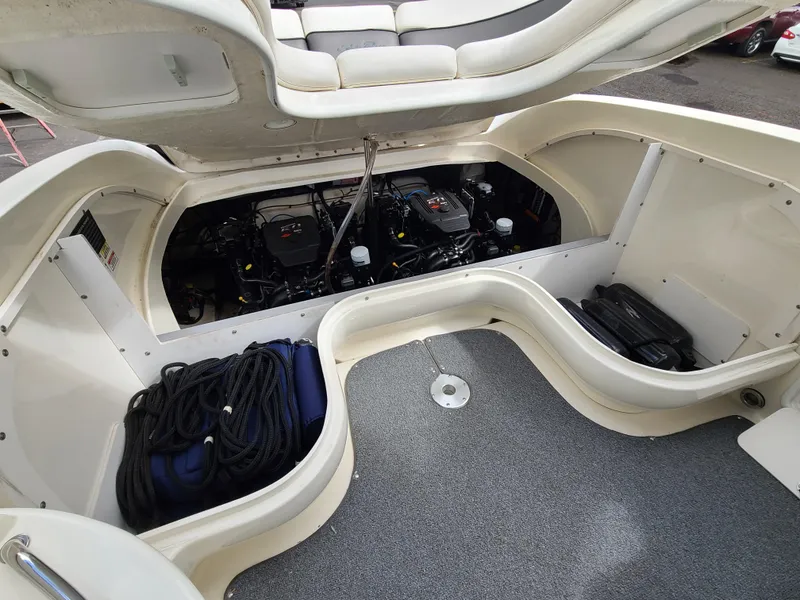 Slide: The Image of 2006 Sea Ray 290 Sun Sport engine compartment with storage and seating. - 15