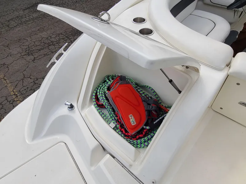 Slide: The Image of 2006 Sea Ray 290 Sun Sport storage compartment with ropes and a red bag. - 17