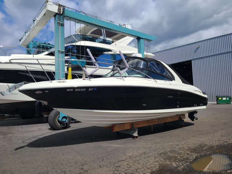 Slide: The Image of 2006 Sea Ray 290 Sun Sport boat on dry dock near marina. - 2