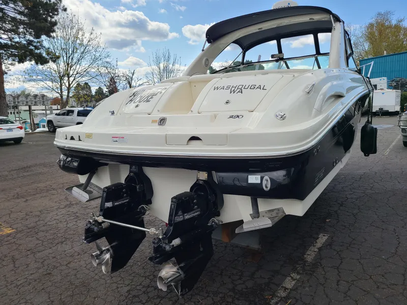Slide: The Image of 2006 Sea Ray 290 Sun Sport boat with dual engines, parked outdoors. - 23