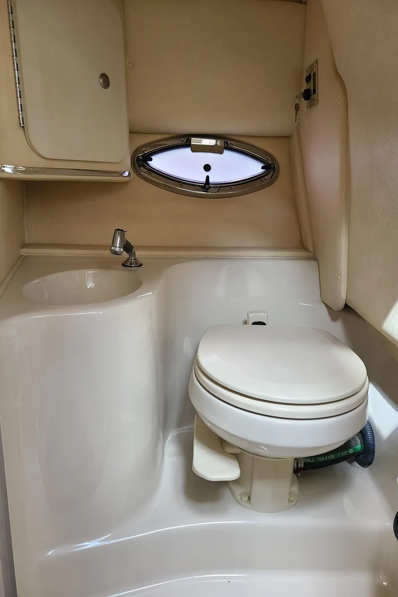 Slide: The Image of 2006 Sea Ray 290 Sun Sport boat bathroom with toilet and sink. - 24