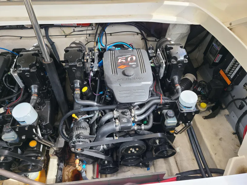 Slide: The Image of Engine compartment of a 2006 Sea Ray 290 Sun Sport boat, showcasing dual engines. - 26