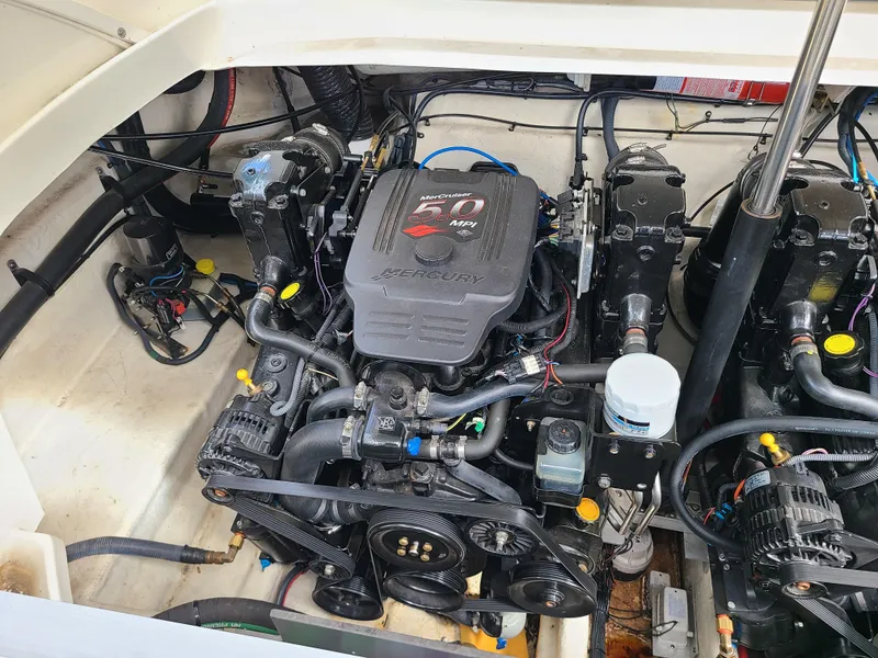 Slide: The Image of Engine compartment of a 2006 Sea Ray 290 Sun Sport boat, showcasing its mechanical components. - 27