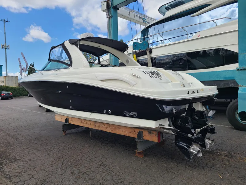 Slide: The Image of 2006 Sea Ray 290 Sun Sport boat on dry dock, black and white exterior. - 5