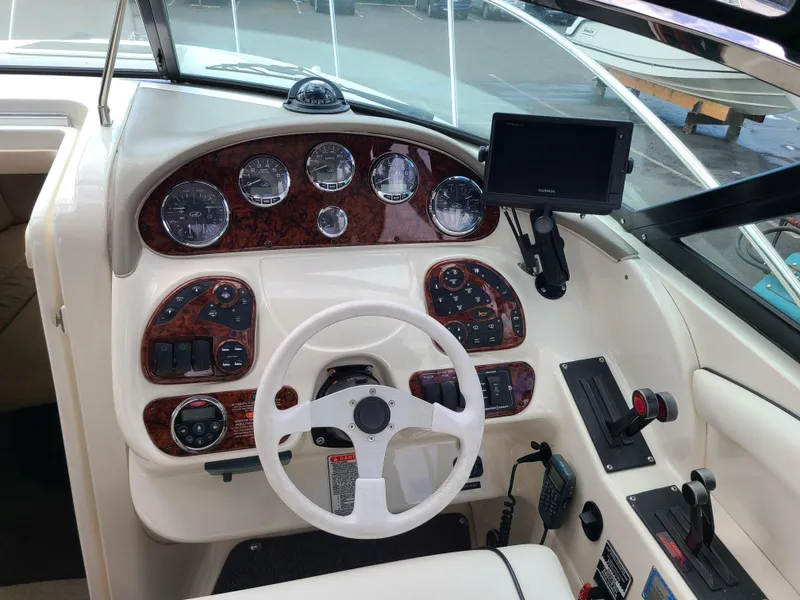 Slide: The Image of 2006 Sea Ray 290 Sun Sport dashboard with steering wheel and control panel. - 7