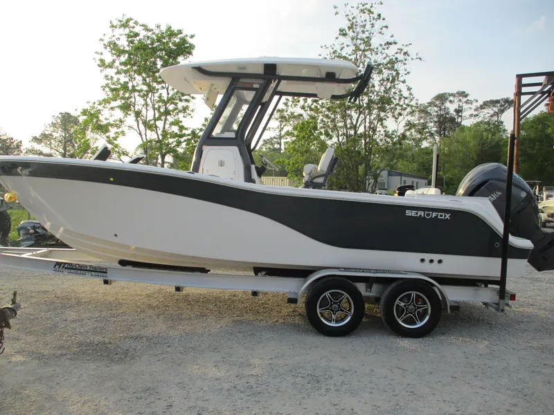 Slide: The Image of 2025 Sea Fox 248 Commander boat on trailer, side view, outdoors. - 0