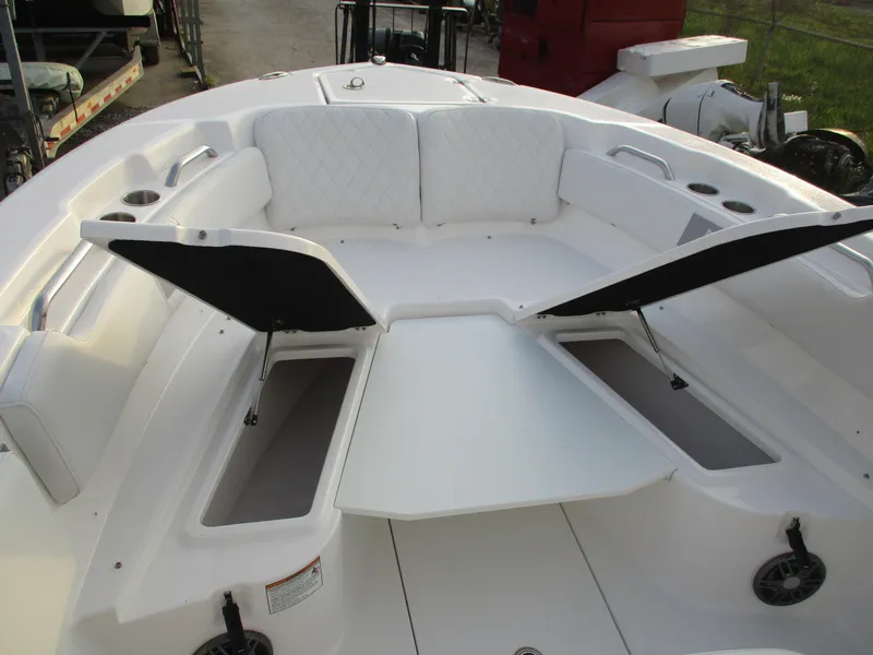 Slide: The Image of 2025 Sea Fox 248 Commander boat interior with open storage compartments and cushioned seating. - 11