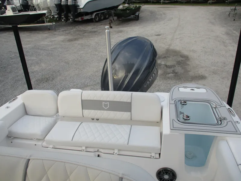 Slide: The Image of 2025 Sea Fox 248 Commander boat interior with seating and motor view. - 13