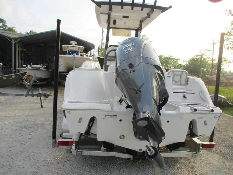 Slide: The Image of 2025 Sea Fox 248 Commander boat with powerful outboard motor, parked on gravel. - 4