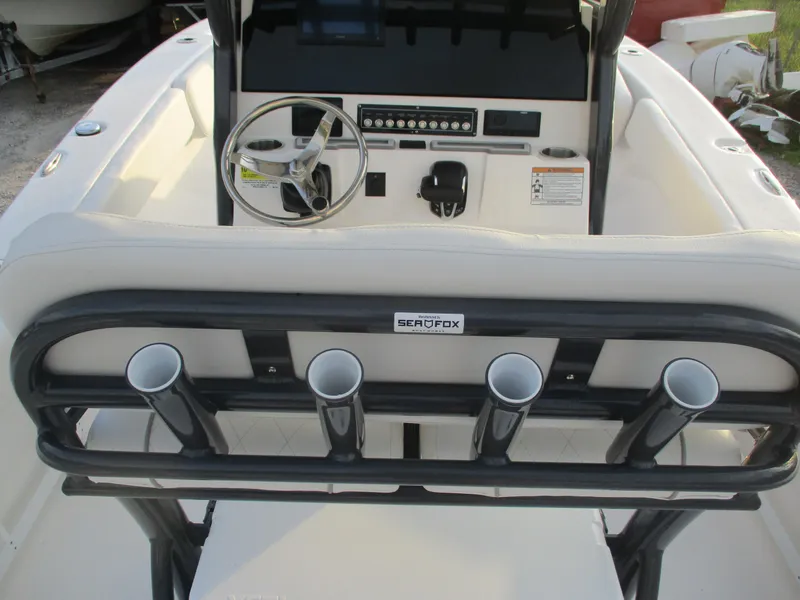 Slide: The Image of 2025 Sea Fox 248 Commander boat interior with steering wheel and rod holders. - 8