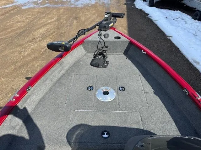 Slide: The Image of 2019 Tracker Super Guide V-16 SC boat deck with trolling motor, red trim, and carpeted surface. - 21