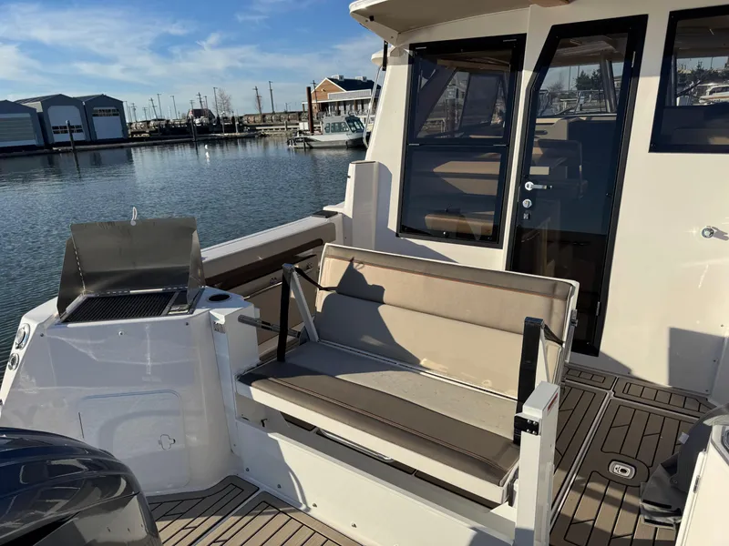 Slide: The Image of 2025 Cutwater C-288 Coupe boat with seating and grill on deck. - 10