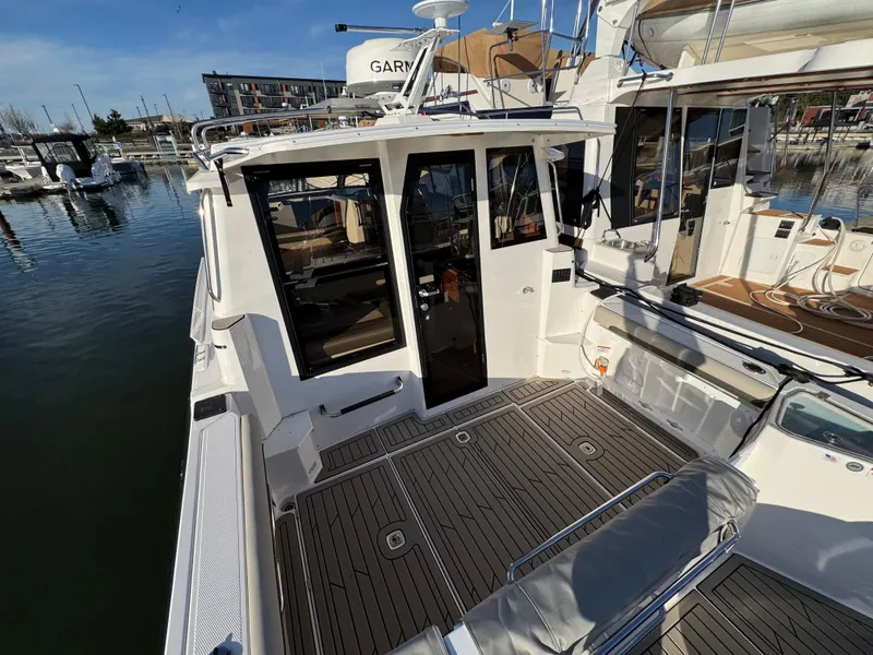 Slide: The Image of 2025 Cutwater C-288 Coupe boat docked, featuring spacious deck and modern design. - 12