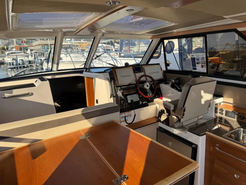 Slide: The Image of Interior of 2025 Cutwater C-288 Coupe boat with helm, seating, and navigation equipment. - 15