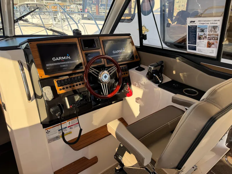 Slide: The Image of 2025 Cutwater C-288 Coupe helm with Garmin displays and modern controls. - 16